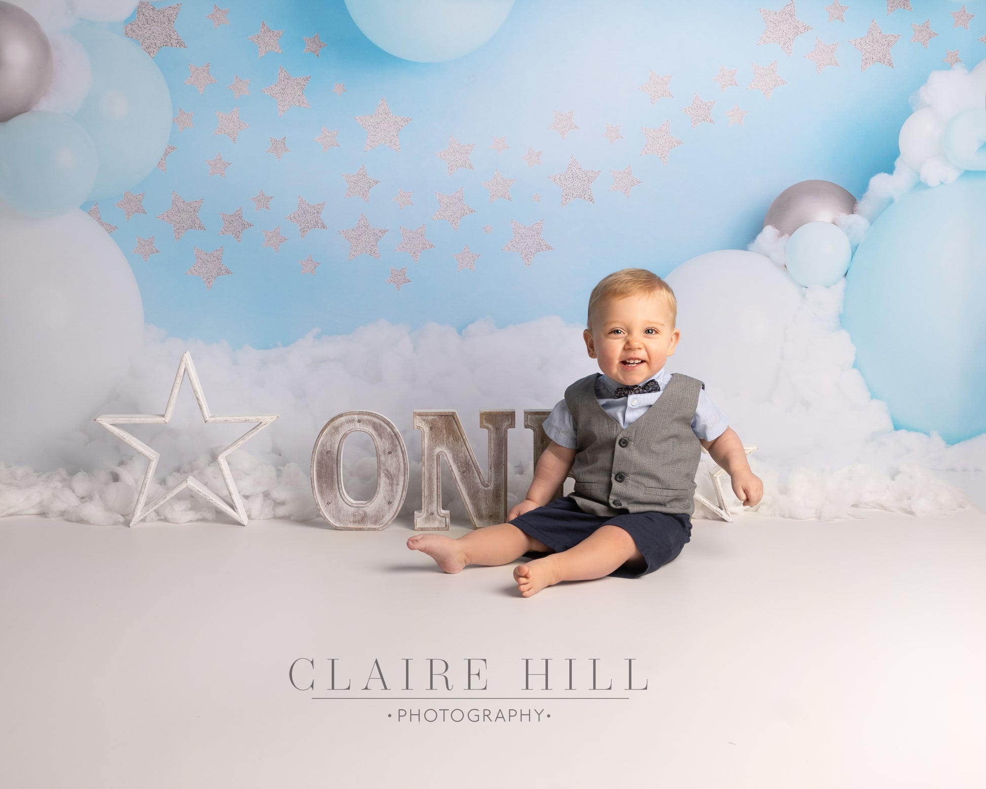 one year old birthday Cake Smash & Splash photoshoot photography by professional photographer Claire Hill based in Wolverhampton West Midlands near Birmingham and Shropshire.