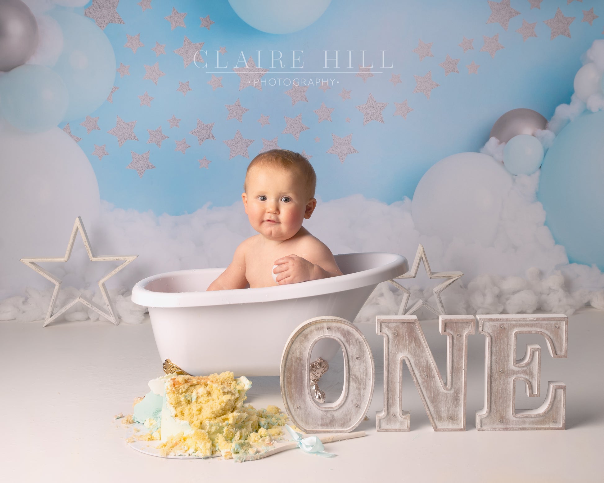 1st birthday Cake Smash & Splash photoshoot photography by professional photographer Claire Hill based in Wolverhampton West Midlands near Birmingham and Shropshire.