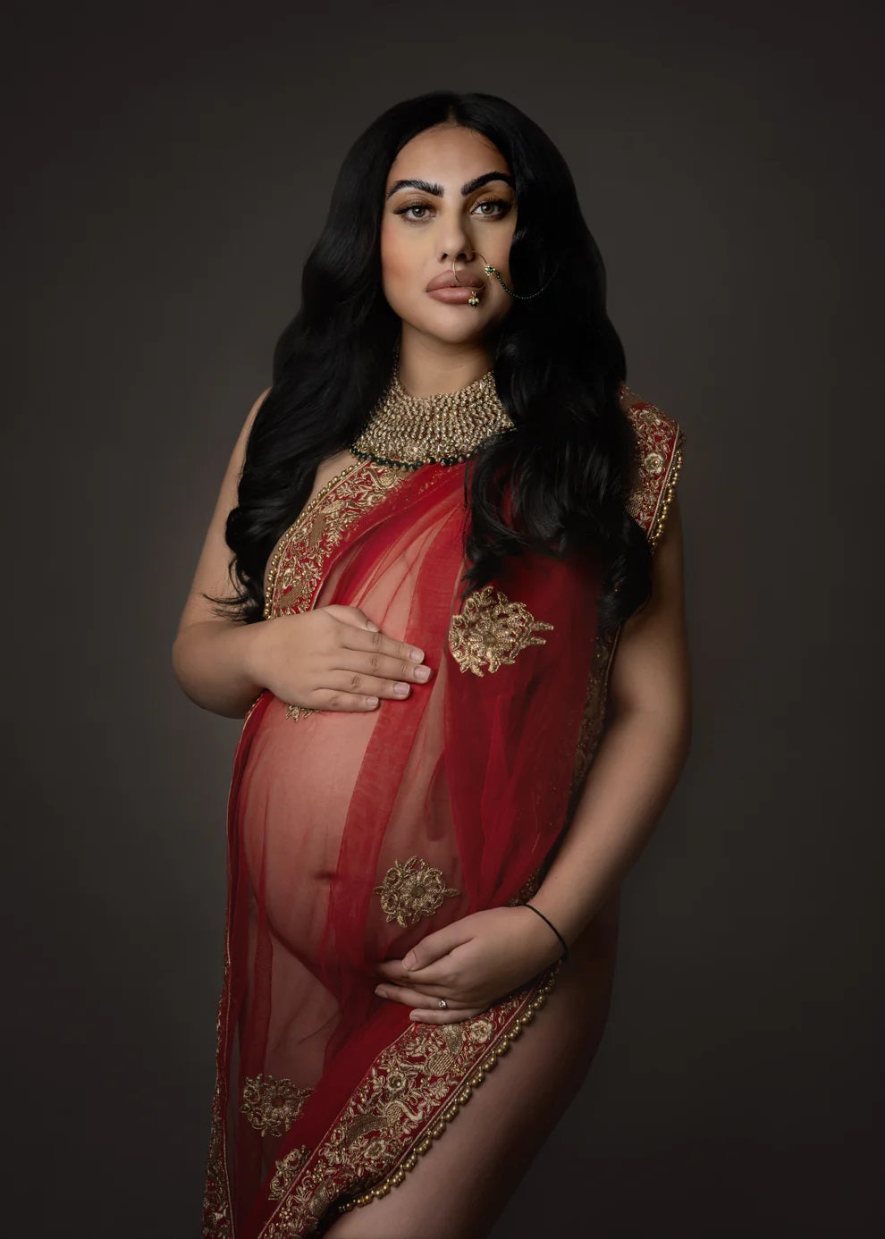 Cultural pregnancy photography session in Birmingham, featuring a mother-to-be in traditional attire, captured by Claire Hill Photography